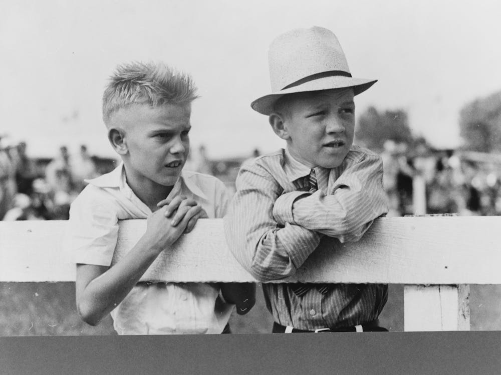 Two Boys Leaning On Fence Watching Parade, State Fair, Donaldsonville, Louisiana By Russell Lee