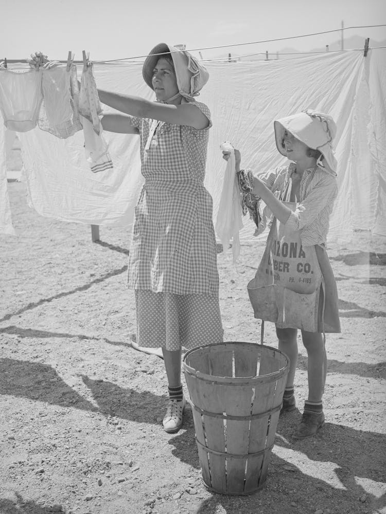 Wife Of Migratory Agricultural Laborer And Daughter Hanging Up The Wash At The Agua Fria Migratory Labor Camp