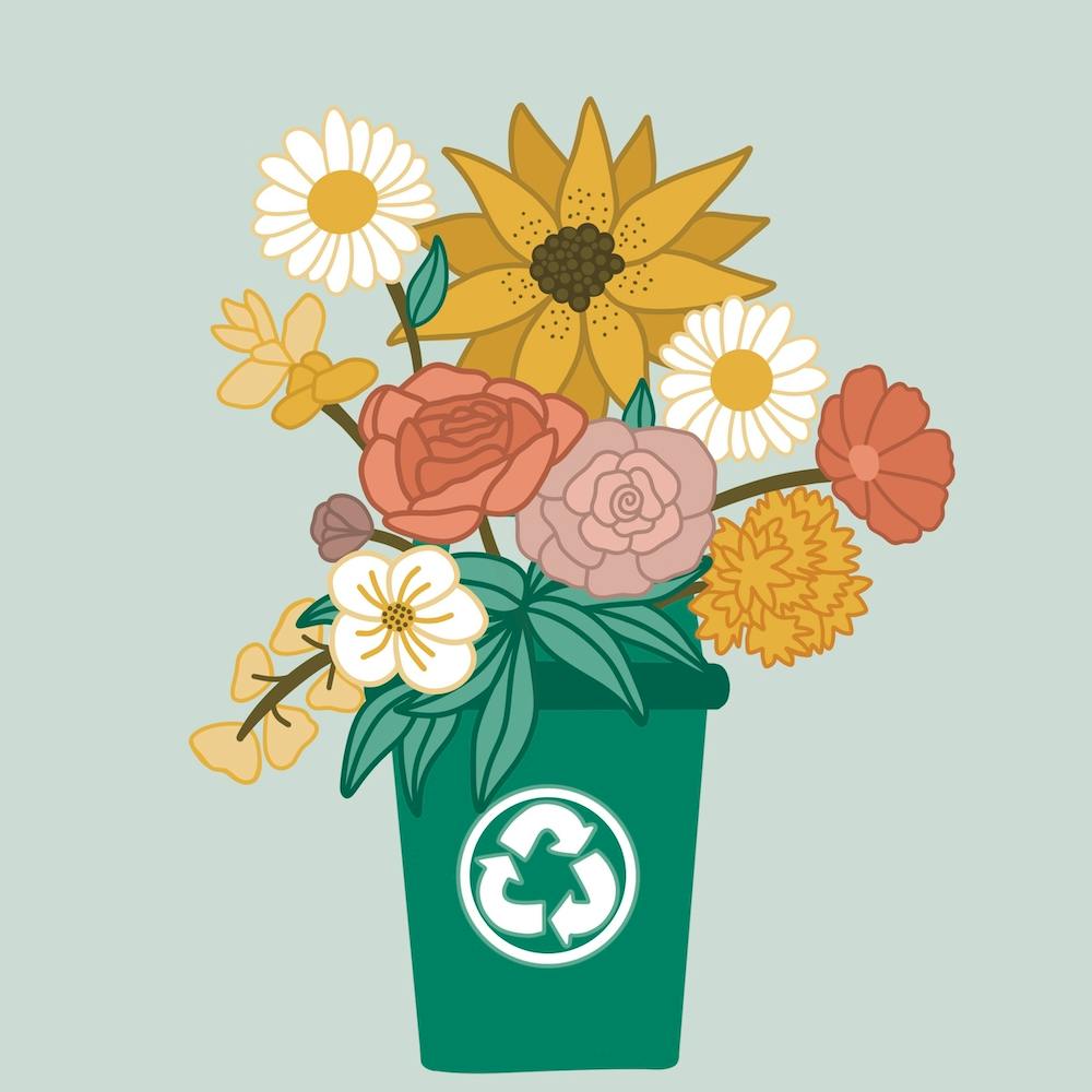 Blumen in einer Recyclingtonne