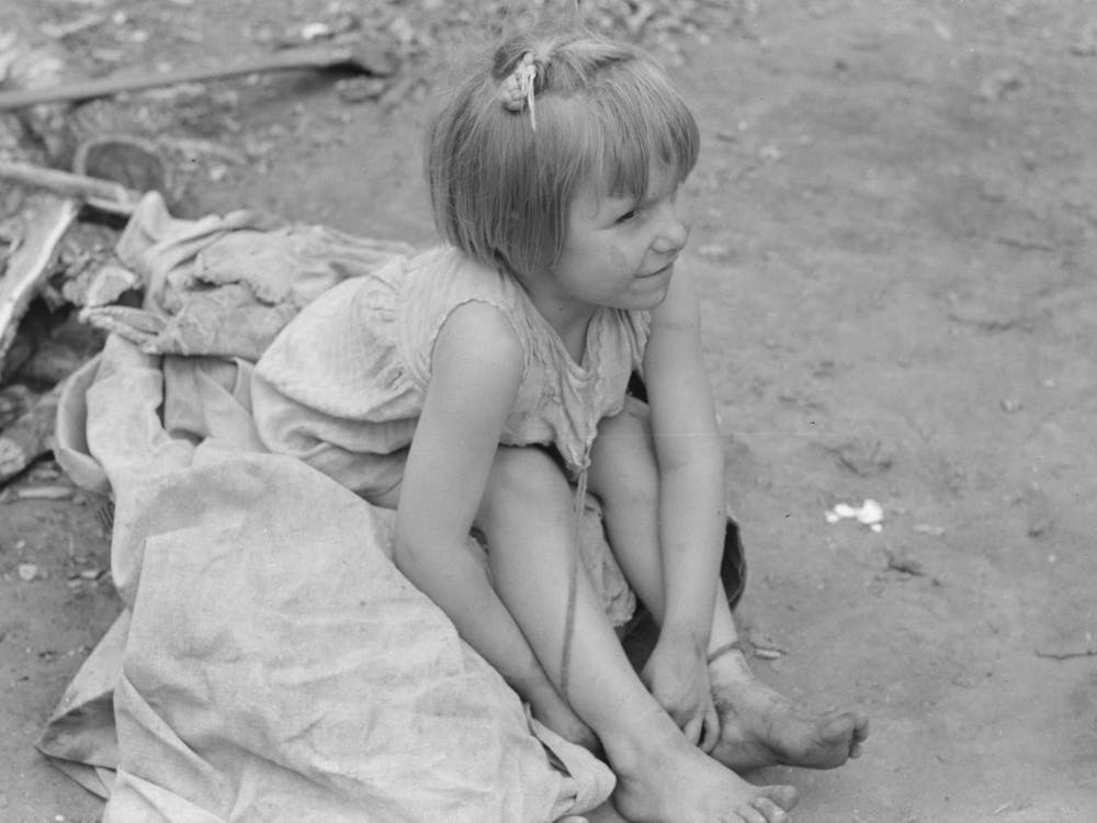Child Of White Migrant Worker Sitting On Cotton Pickers Sacks Near Harlingen, Texas By Russell Lee