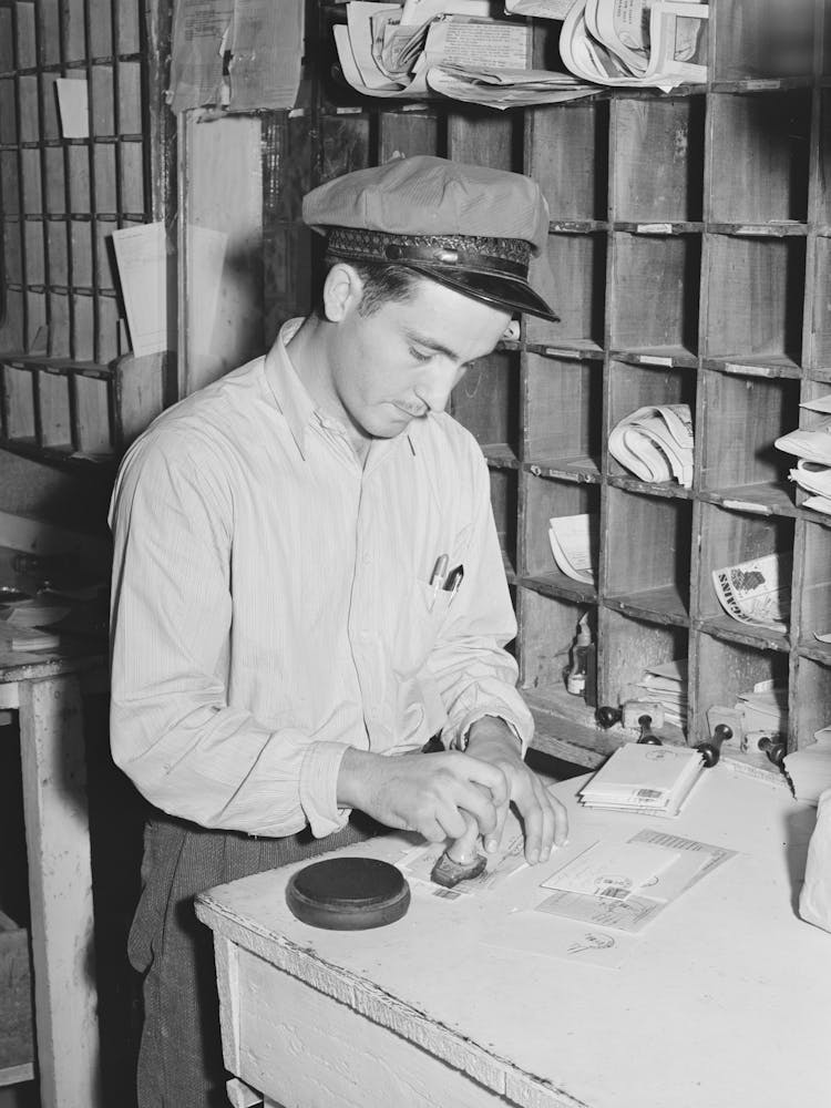 Postmaster Cancelling Stamps, Concho, Arizona By Russell Lee