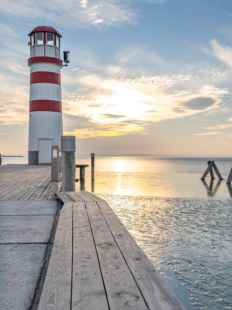 Red and White Lighthouse At Sunset