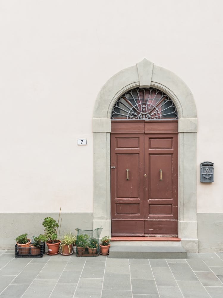 Wooden Red Door And Plants In Tuscany In Italy