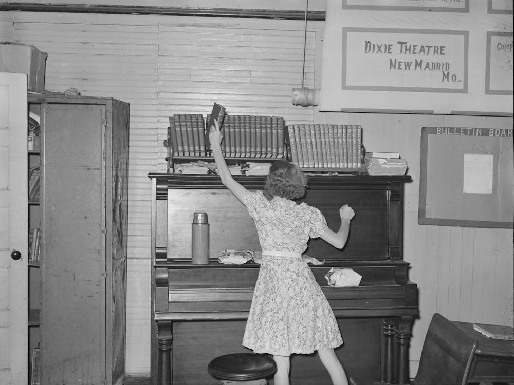 Child Removing Book From Shelf In School Room, Southeast Missouri Farms By Russell Lee