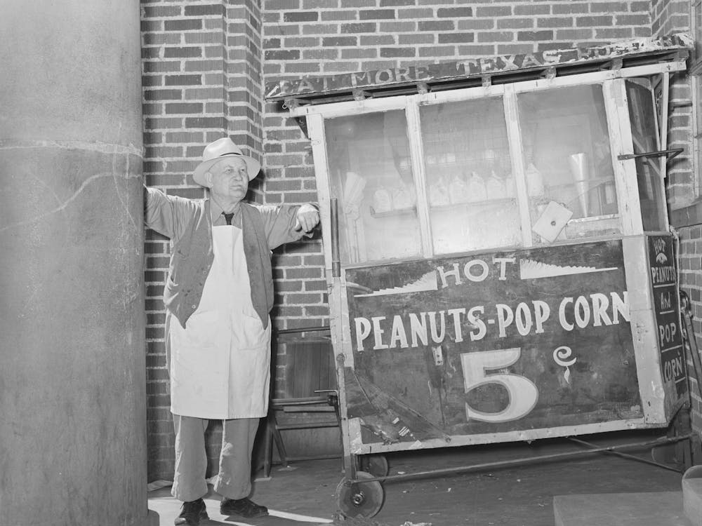 Popcorn Man In Front Of Bank, San Augustine, Texas By Russell Lee