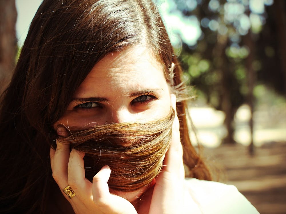 Woman Hiding Her Face With Her Hair Looking At Camera 1