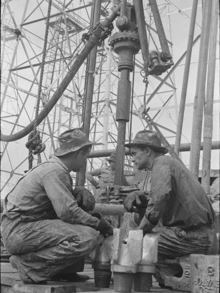 Untitled Photo, Possibly Related To Oil Drillers Talking With Bits In Front Of Them And Drilling Equipment In Background