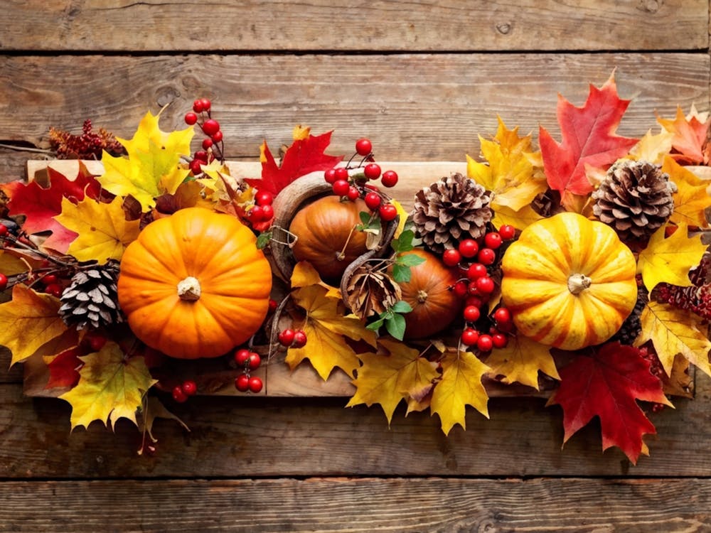Autumn Themed Table Decor Featuring An Assortment Of Yellow And Orange Leaves Acorns Amidst A Garde (3)