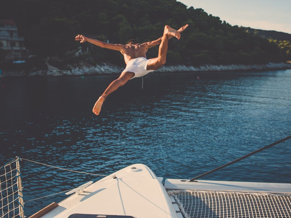 Man Jumping Off A Yacht