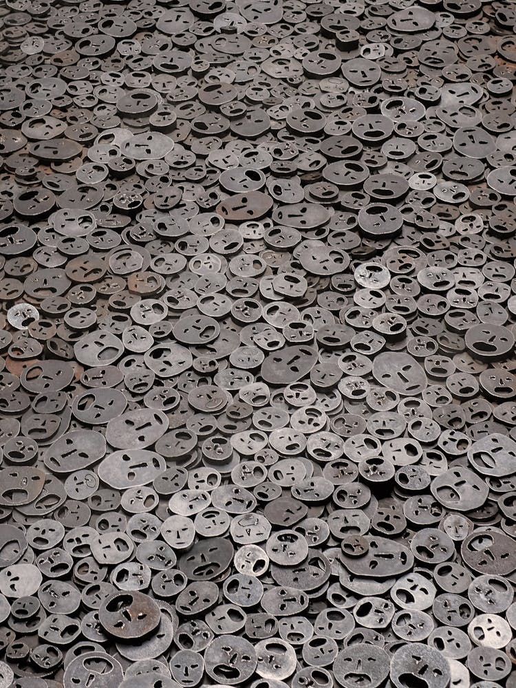 Berlin, Germany I Shalekhet metal faces at the Jewish Museum Berlin, a powerful and emotional art installation captured in a minimalist black and white photography graphic repetition abstract forms