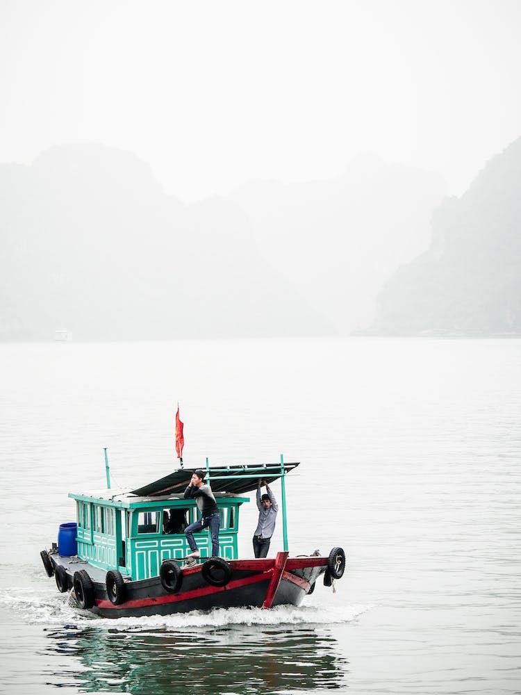 Small Boat On A Misty Halong Bay Vietnam