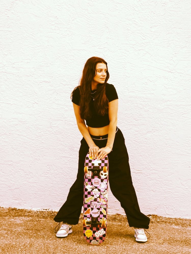 Standing Woman Leaning On Skateboard 16920073