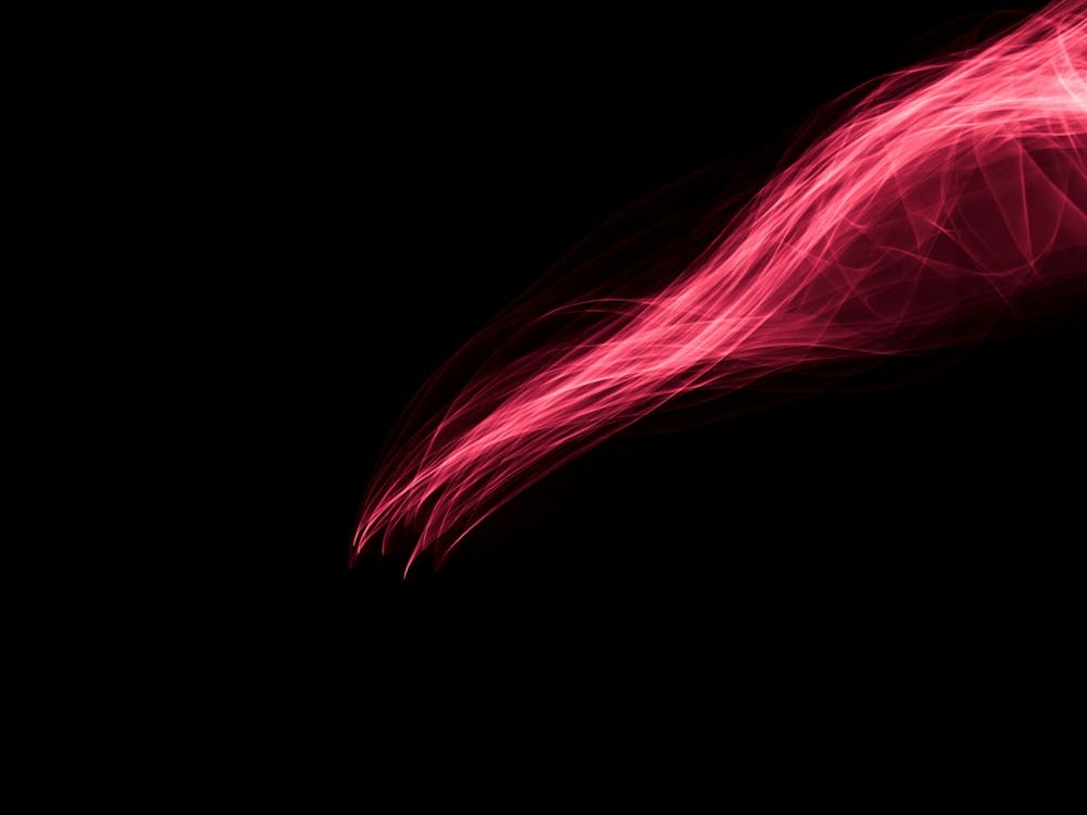Glowing Abstract Curved Light Red And Pink Lines Rays