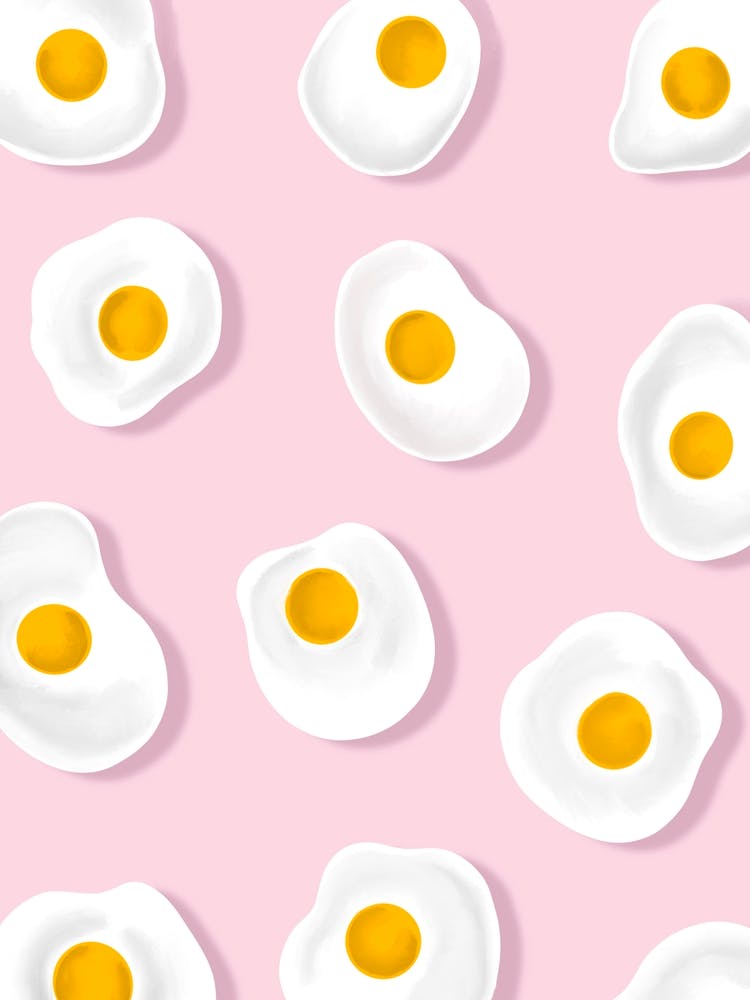 Fried Eggs On Pink Background