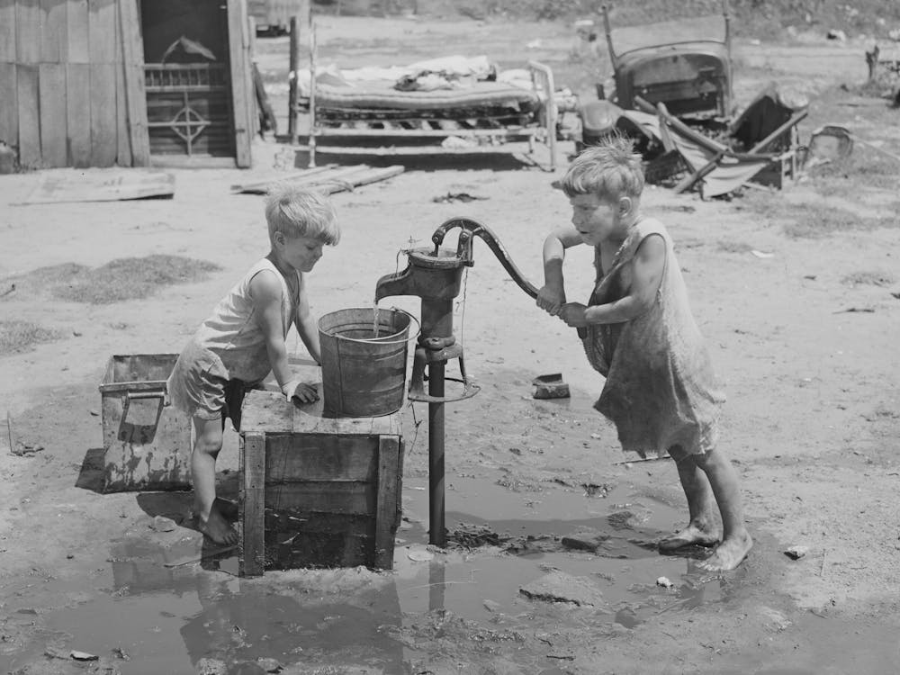 Children Of Mays Avenue Camp Pumping Water From Thirty Foot Well Which Supplies About A Dozen Families