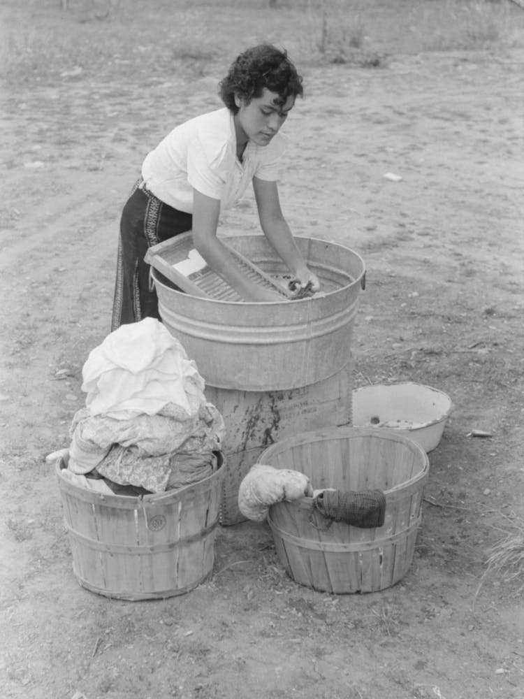 Daughter Of Spanish American Farmer Washing, Chamisal, New Mexico By Russell Lee