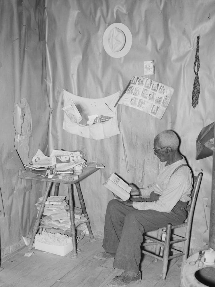 New Madrid County, Missouri, Old Sharecropper Reading The Bible In His Living Room By Russell Lee
