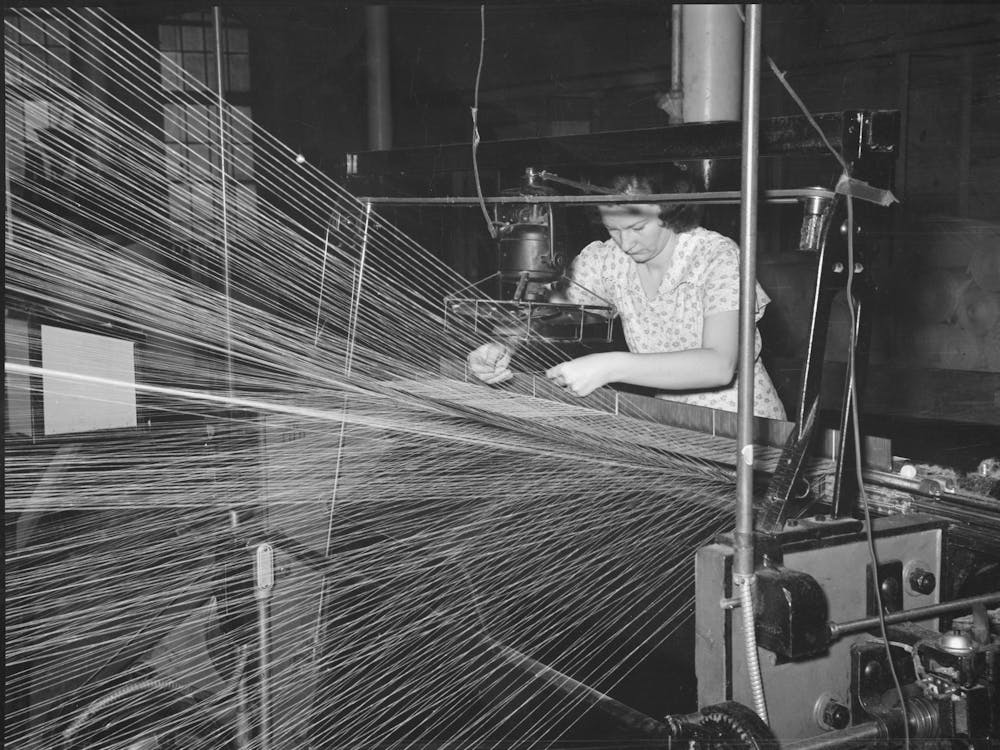 Operator Repairing Break In Thread In Warp Winding,Laurel Cotton Mills, Laurel, Mississippi By Russell Lee