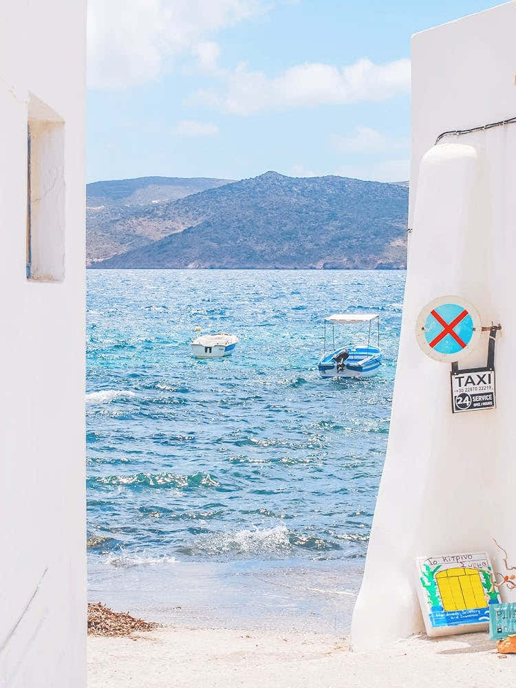 Milos, Greece I Mediterranean sea view to blue white aesthetic of Cyclades islands like Santorini from small fishing village of Klima for a wild savage nature boho pastel summer mountain landscape photography