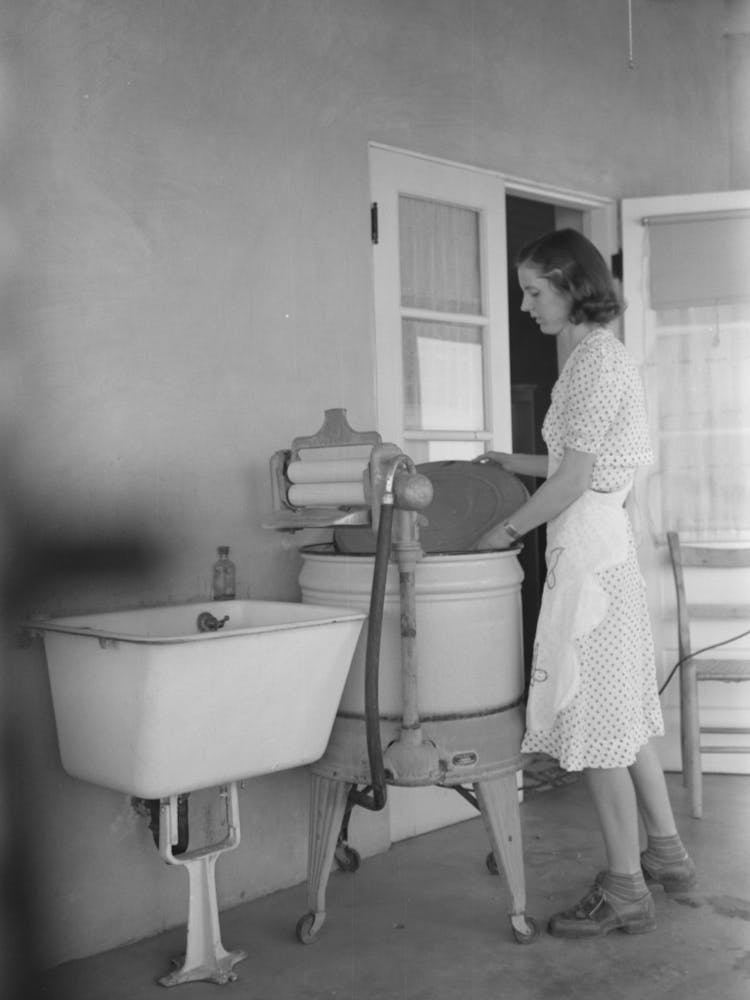 Woman Living At The Casa Grande Valley Farms, Pinal County, Arizona, Removing The Cover From Her Electric Washing