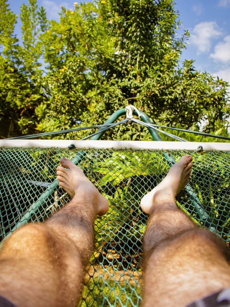 Man Laying In Hammock On A Summer Day