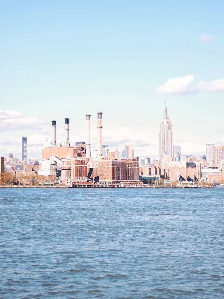 New York, USA I Vintage Manhattan skyline view photography from arty Williamsburg to Brooklyn with the Hudson River in front for an industrial panorama with autumn blue and orange aesthetic on skyscrapers