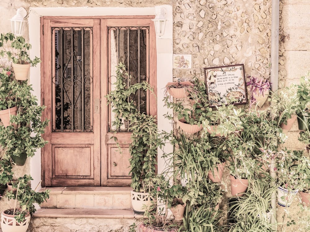 Rustic idyllic view of mediterranean house with potted plant decoration