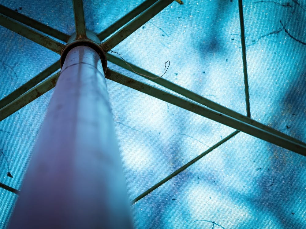 Abstract Image Of A Blue Parasol With Metal Frames
