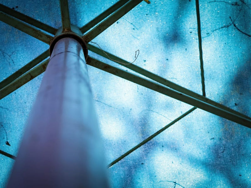 Abstract Image Of A Blue Parasol With Metal Frames