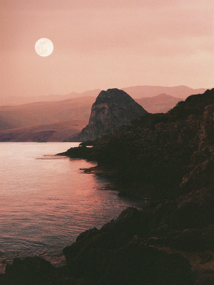 Rocky Coast With The Moon And The Sea