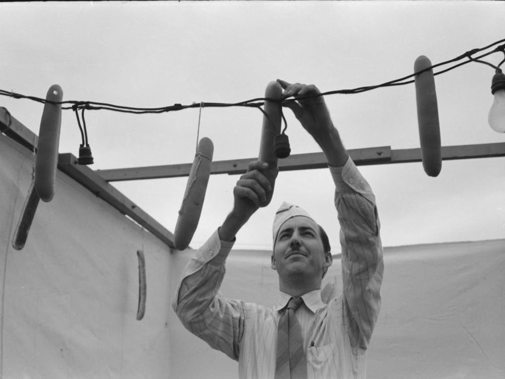 Hamburger Stand Proprietor Hanging Up The Foot Long Buns, County Fair, Gonzales, Texas By Russell Lee