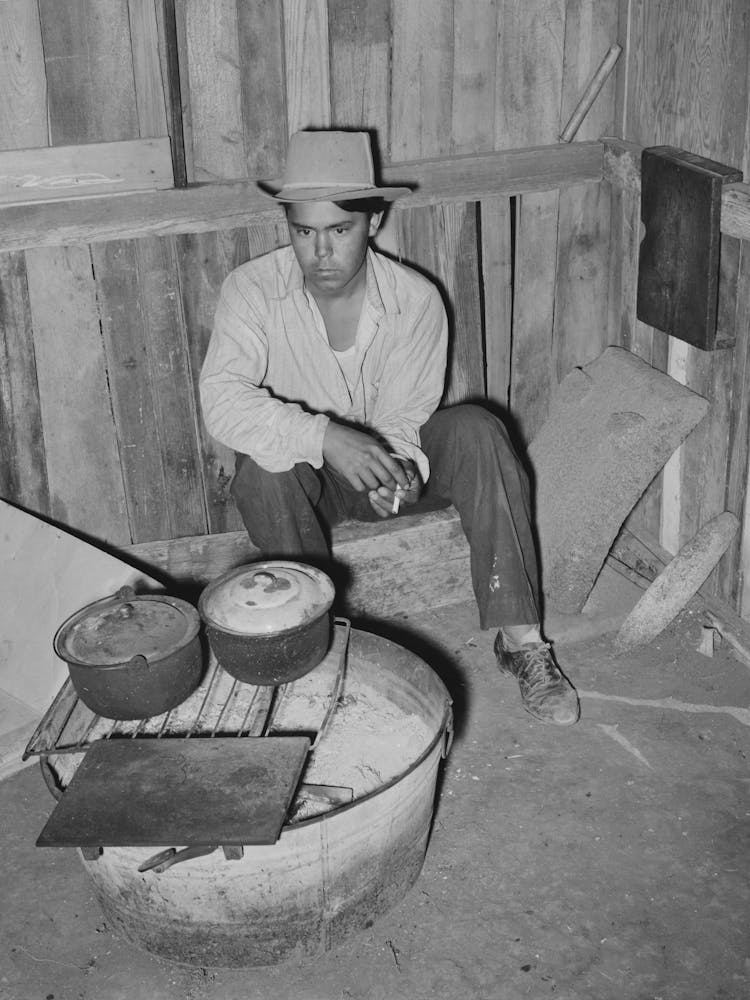 Mexican Man Sitting By Makeshift Cooking Stove, It Is Not Unusual To Find Mexicans Cooking Over These Fires And