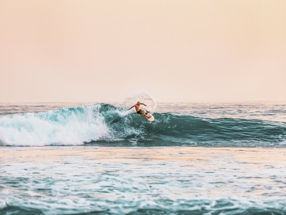 Surfer Catching Waves