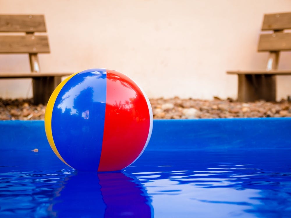 Colorful Beach Ball Floating In Pool 1