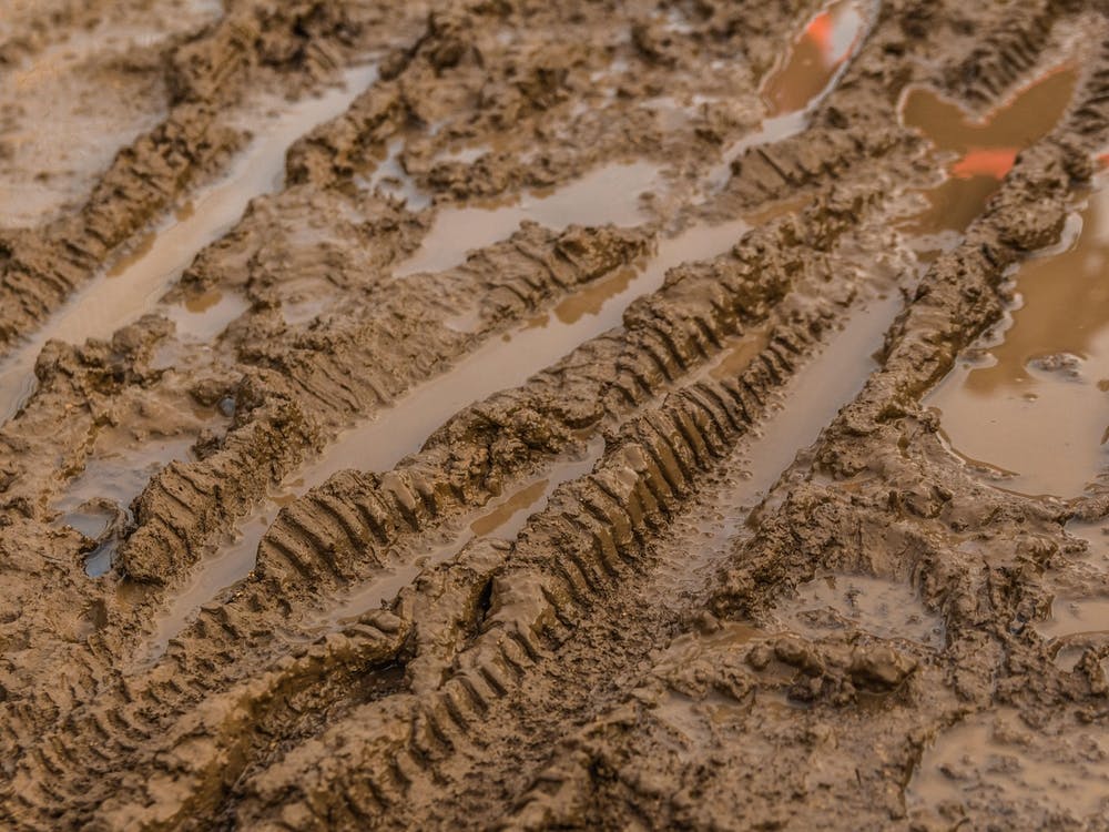 Texture Of Wet Brown Mud With Bicycle Tyre Tracks 4