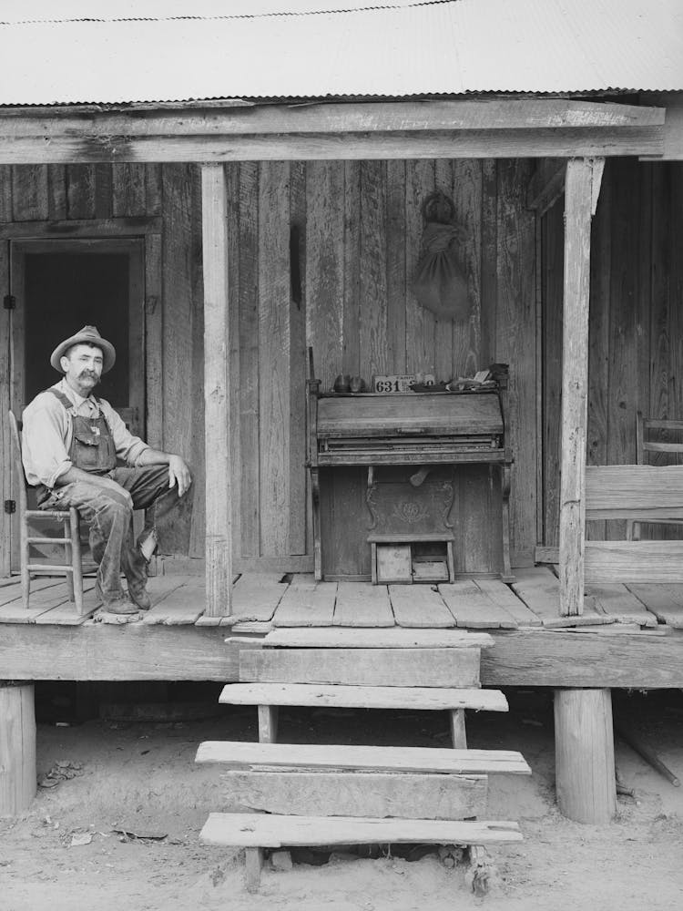 W E Smith, Farmer Near Morganza, Louisiana, Sitting On The Front Porch Of His Home By Russell Lee