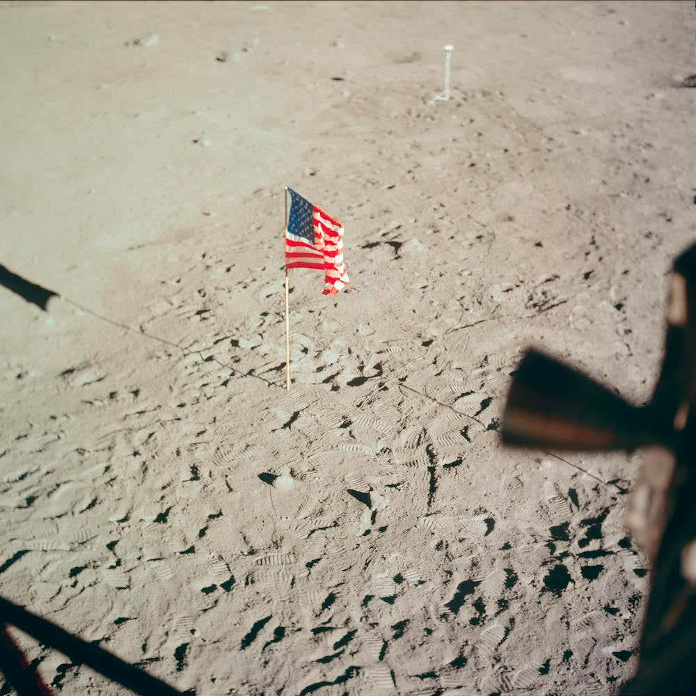 The Flag Of The United States And The Footprints Of Astronauts Neil A