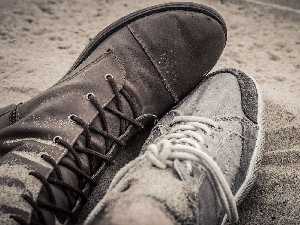 Shoes Of Man And Woman Lying Next To Each Other On The Sand 1