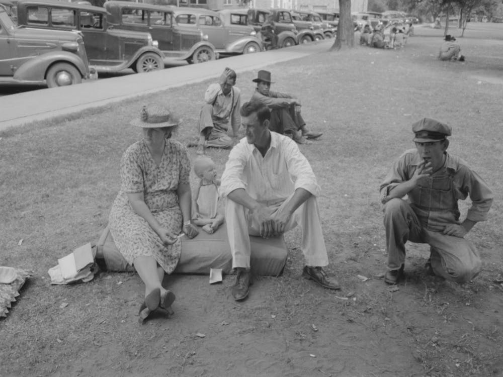 Farm People Sitting On Automobile Cushion In Square, Tahlequah, Oklahoma By Russell Lee