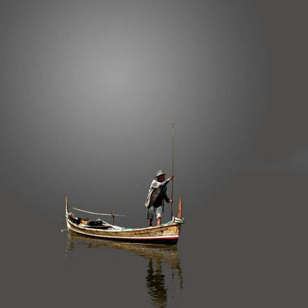 Man Fishing In A Boat