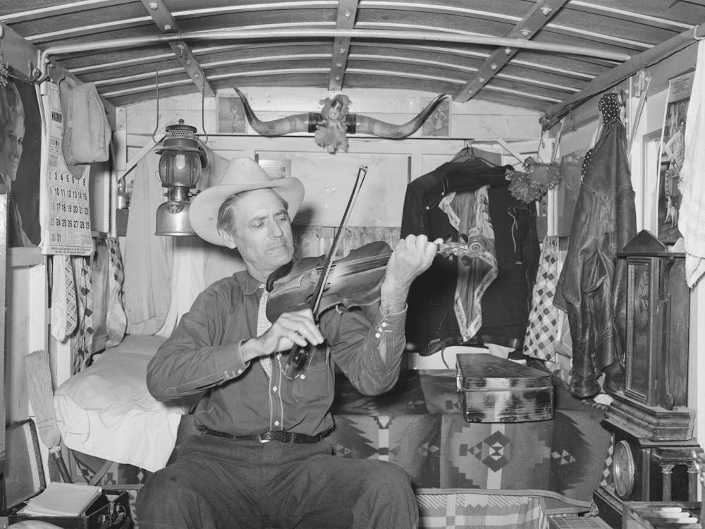 Mr, Bias Playing The Fiddle In His Trailer Home, He Is A Former Cowboy Who Travels Over The Country, He Has A Small