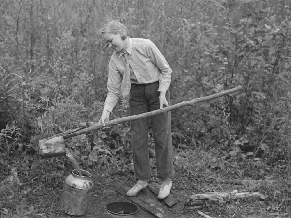 Untitled Photo, Possibly Related To Filling Can With Water From Shallow Well On Farm Near Northome, Minnesota B