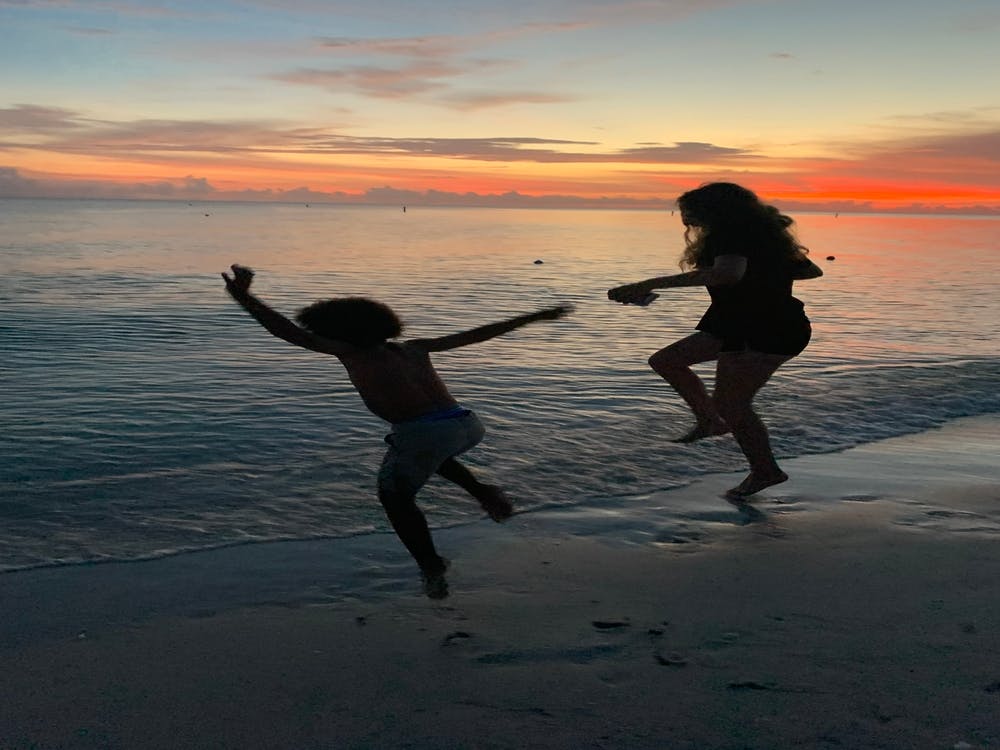 Jumping into the beach sunset
