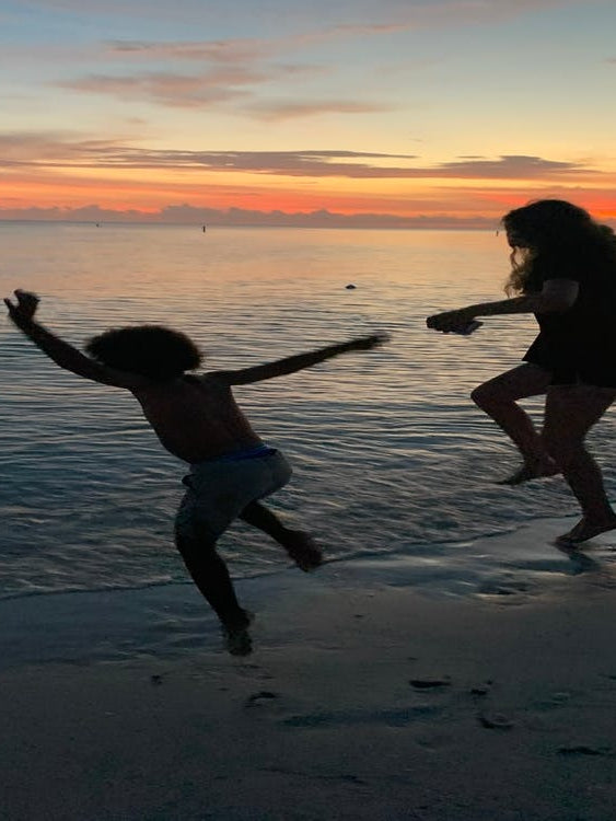 Jumping into the beach sunset