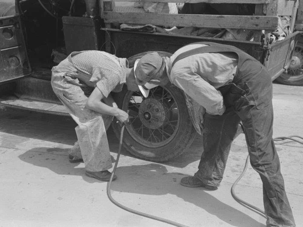 Migrants On The Road Checking Tires At Filling Station Near Henrietta I E Henryetta Oklahoma By Russell Lee
