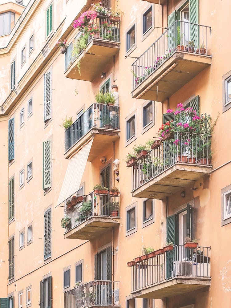 Rome, Italy I Summer roman building with floral balconies, soft light and pastel tones aesthetic with authentic urban architecture photography capturing Italian charm, the spirit of la dolce vita