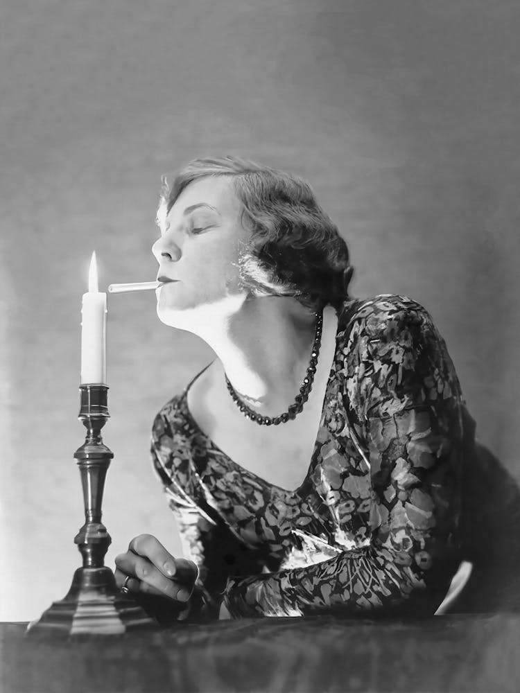 Woman Lighting a Cigarette With A Candle, Black and White Old Photo, Vintage Woman Portrait