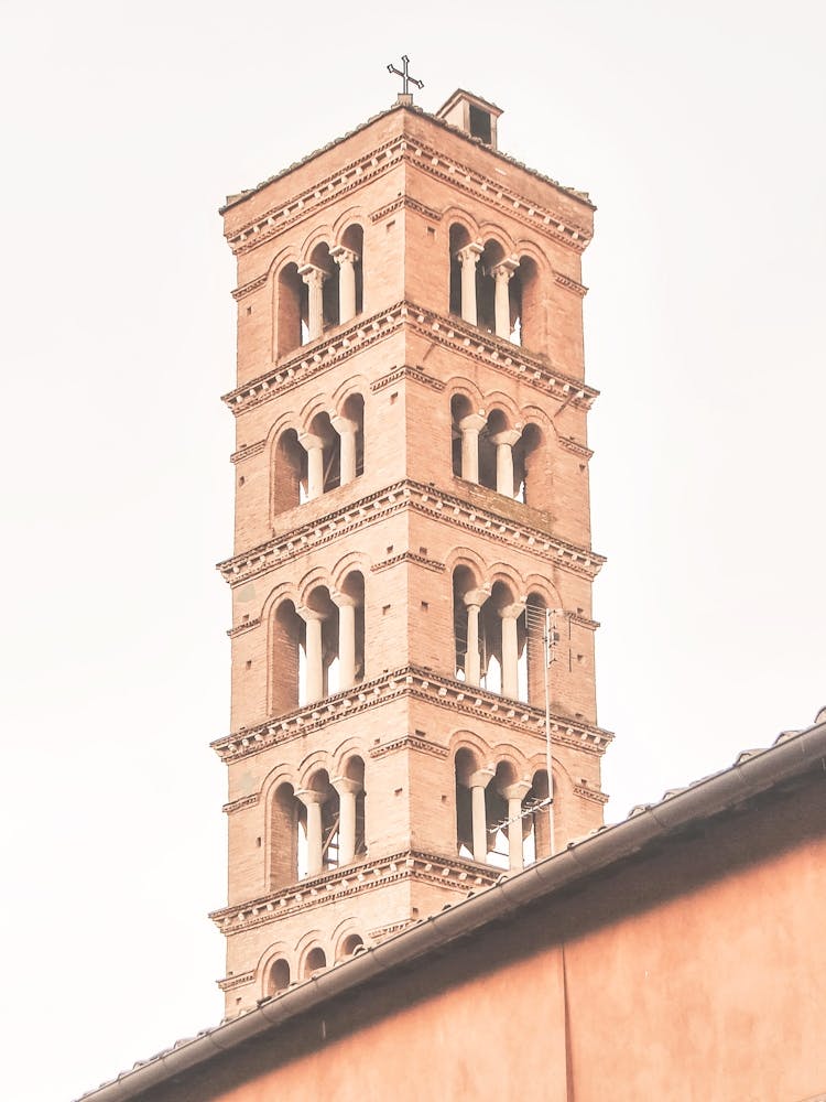 Rome, Italy I Pastel orange bell tower of a church in minimalist authentic geometric architecture photography capturing the warm and timeless of italian la dolce vita in the Mediterranean aesthetic