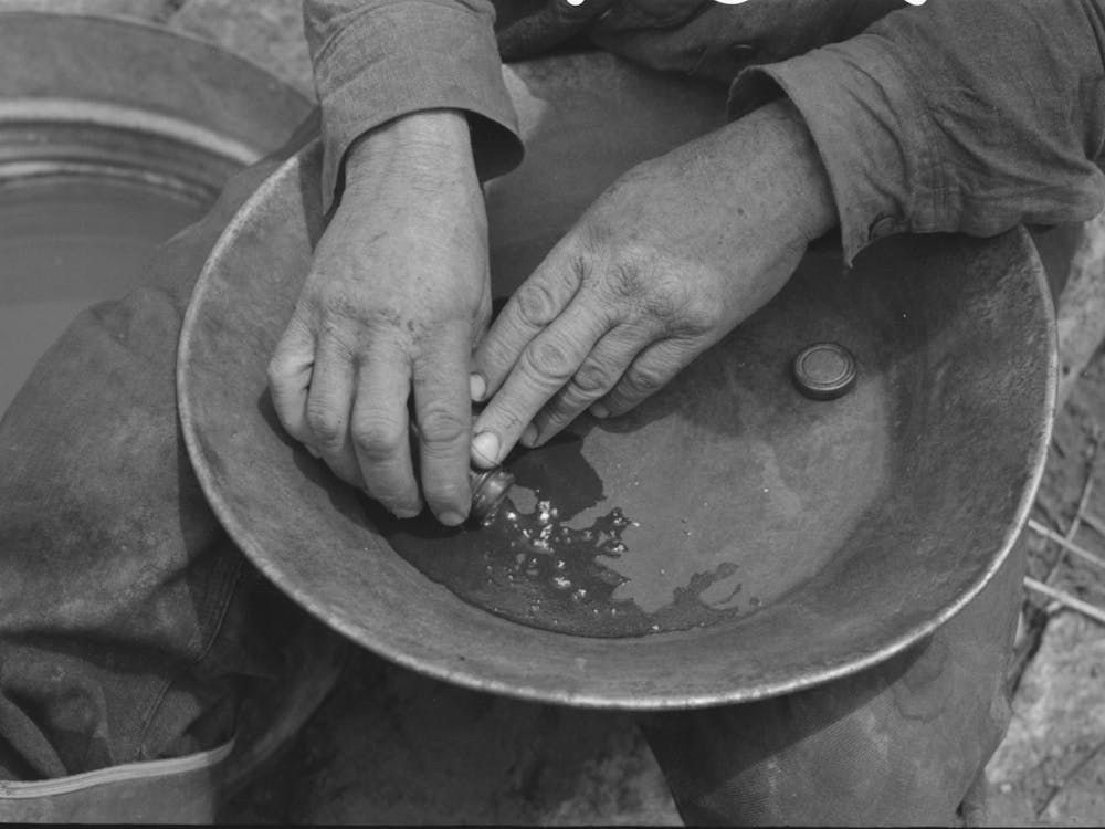 Pouring Mercury From Small Tube Into Pen Which Contains Flour Gold Mixed With The Natural Dirt