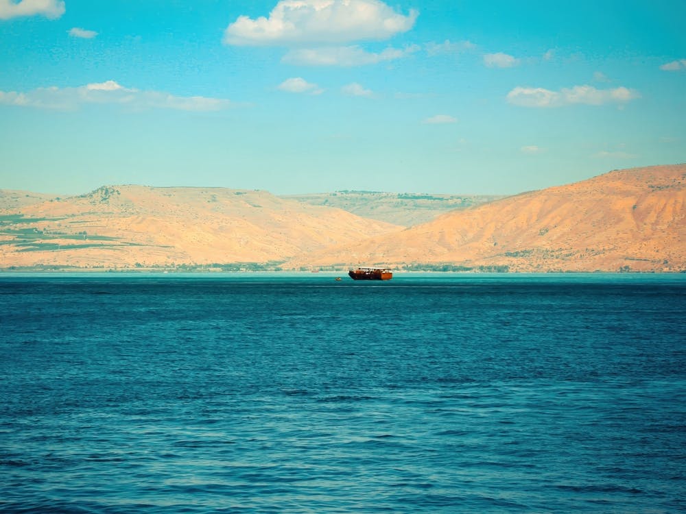 Brown Wooden Boat Sailing In Sea Of Galilee